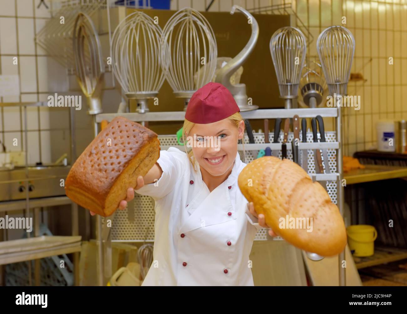 A young baker girl takes up her work in a bakery. She is seen in the