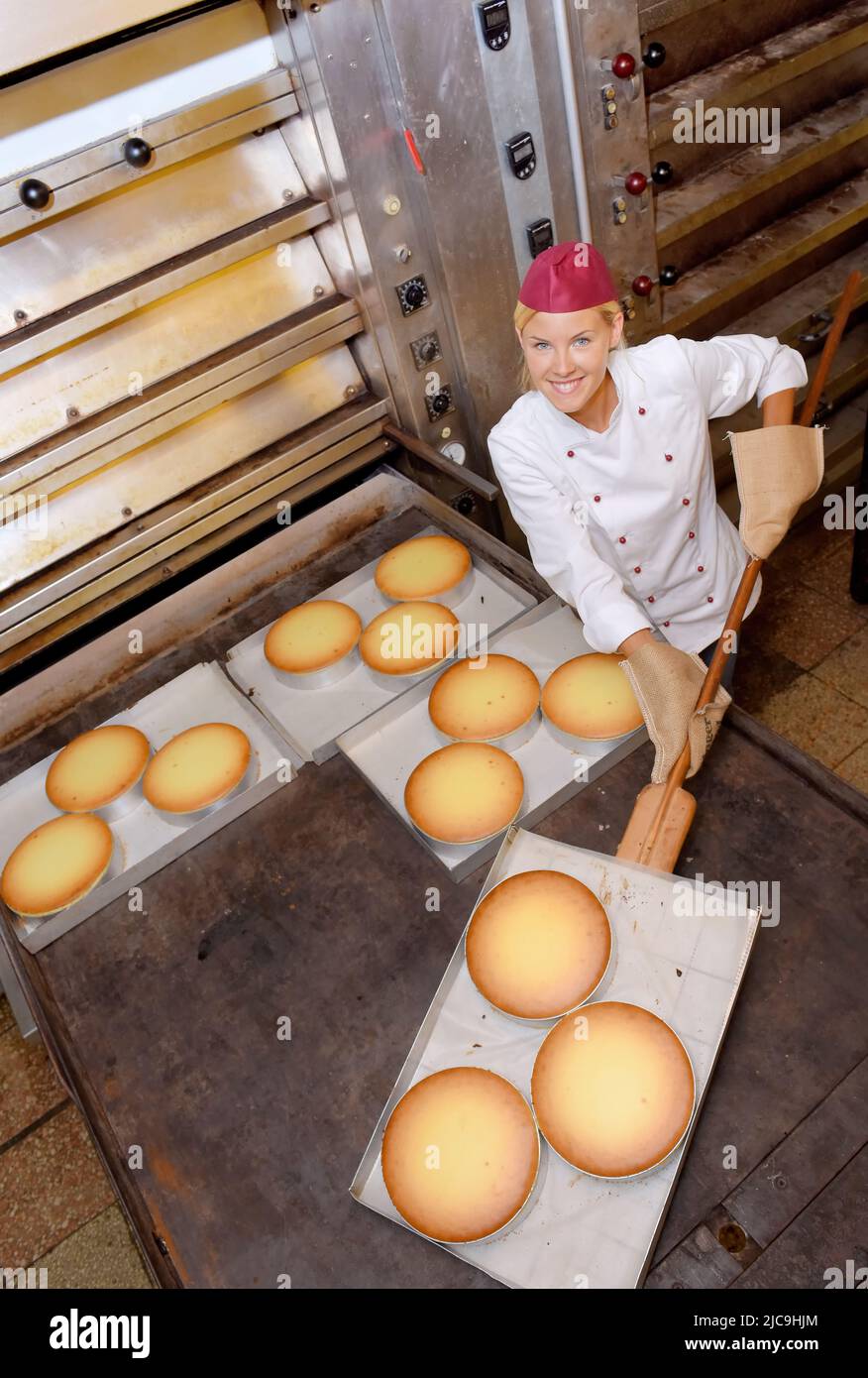 A young baker girl takes up her work in a bakery. She is seen in the