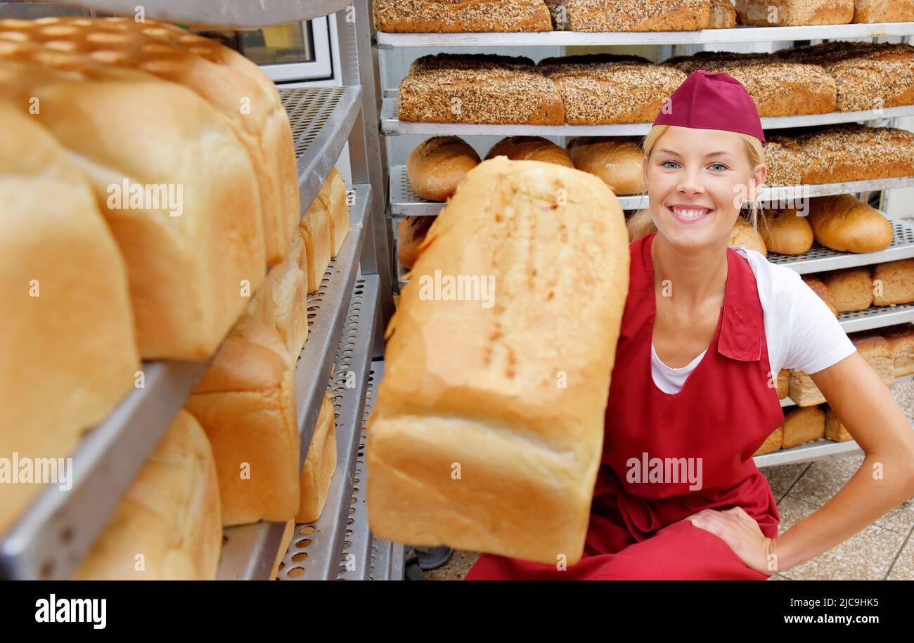 A young baker girl takes up her work in a bakery. She is seen in the