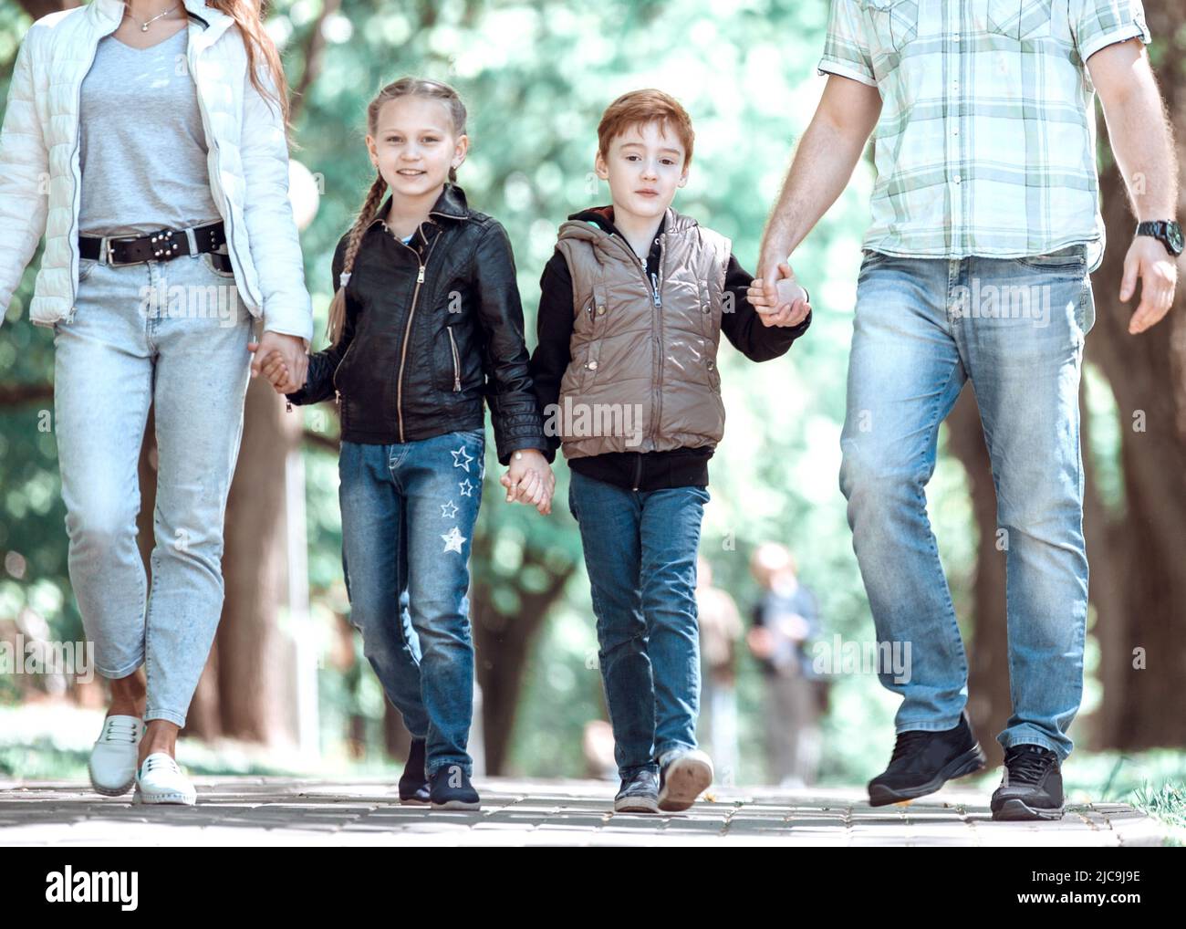 family with two children on a walk in the Park Stock Photo Alamy