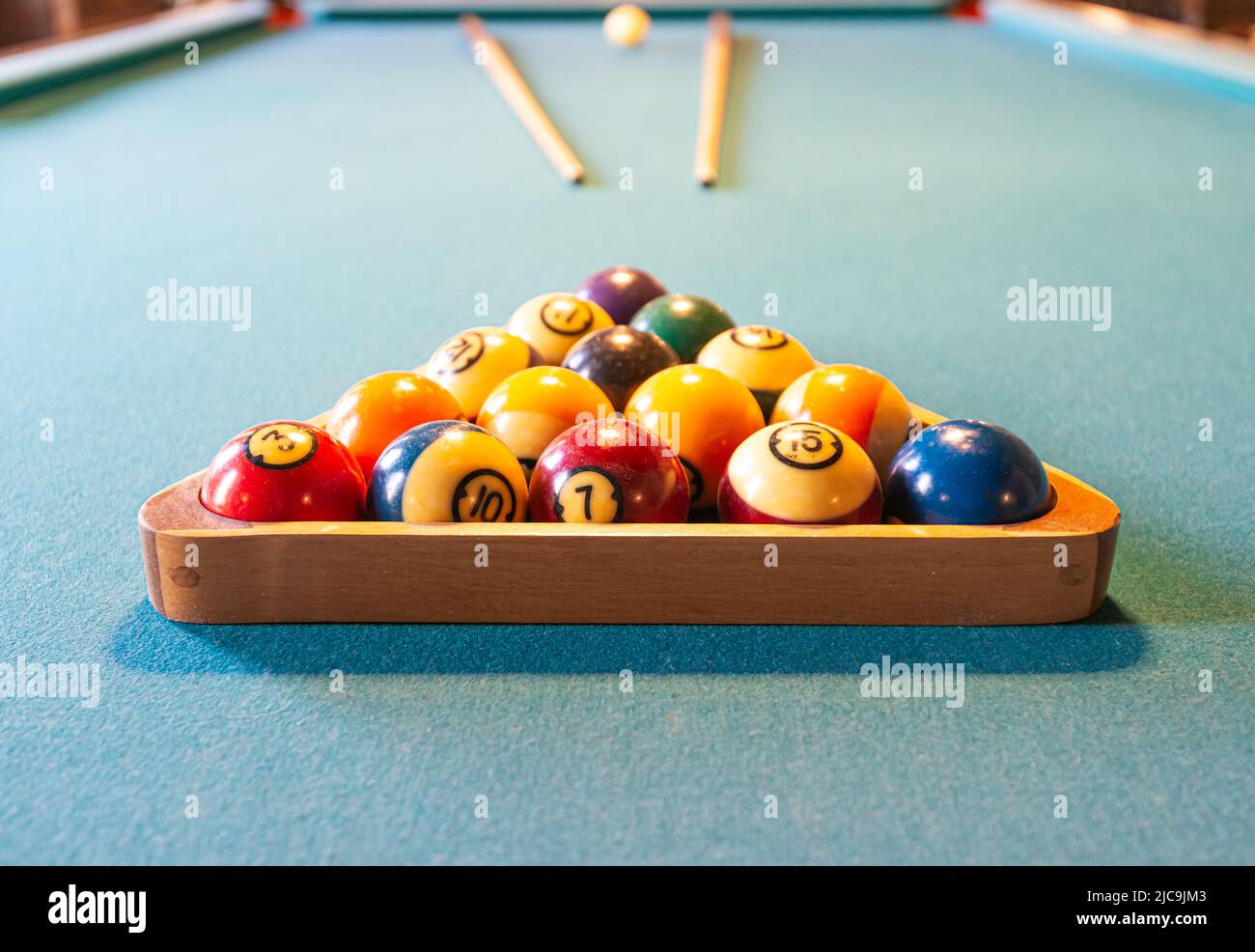 Billiard table with balls and cues Stock Photo