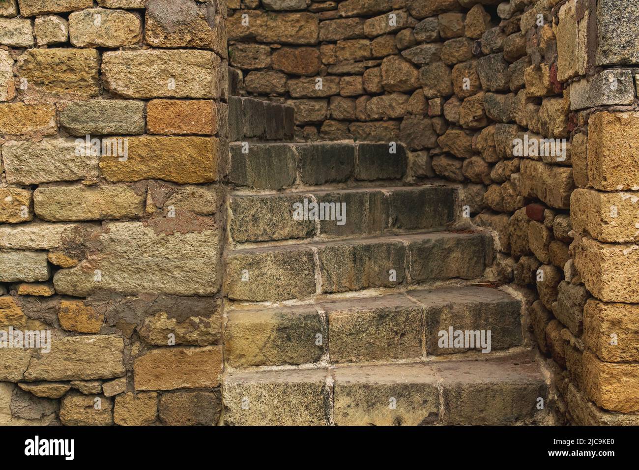 passage with a spiral staircase in an ancient stone wall Stock Photo ...