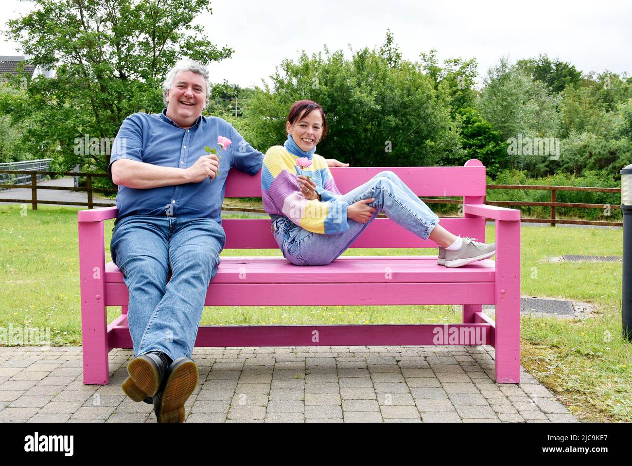 St. Shanaghan House, Ardara, County Donegal, Ireland. 11th June 2022.  TD Thomas Pringle and Senator Eileen Flynn open a new initiative whereby benches on the public footpath through the sheltered housing complex are painted pink to make the local people aware of issues surrounding breast cancer in the community. Credit: Richard Wayman/Alamy Live News Stock Photo