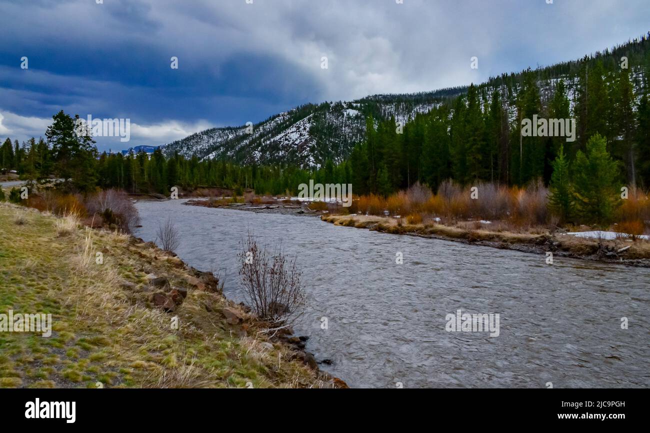 Mountain river with muddy water, melting snow in the mountains