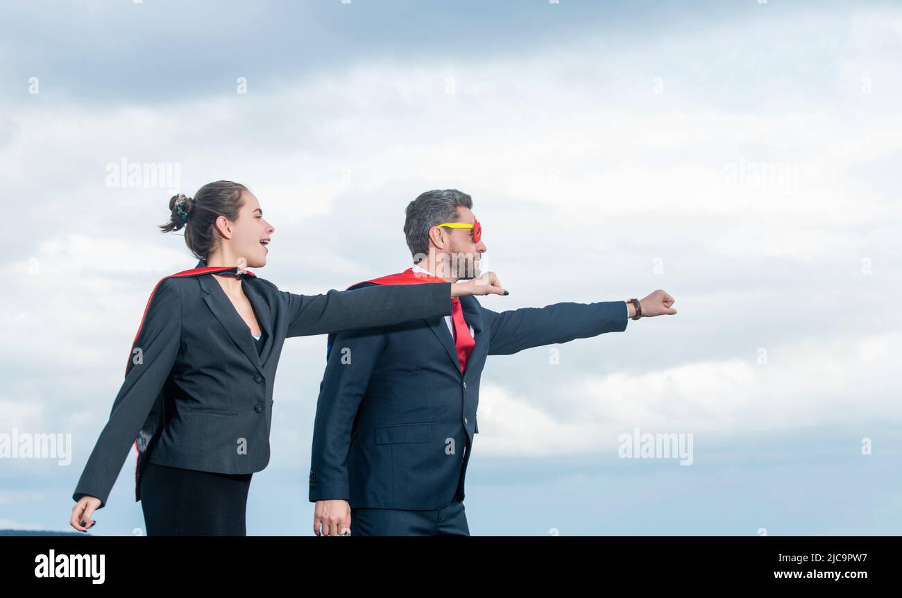 business couple in superhero suit on sky background. aspiration Stock Photo