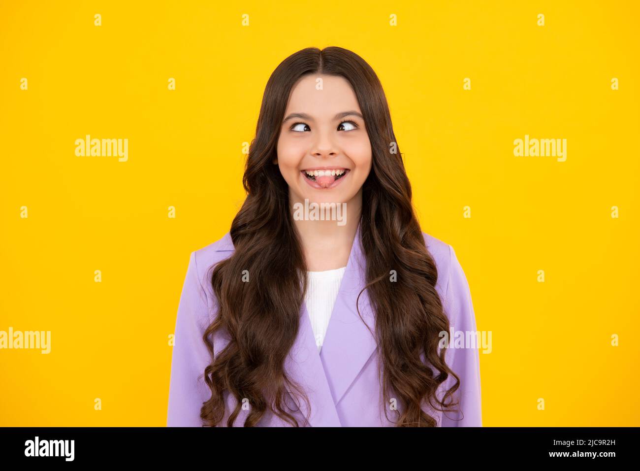 Funny face. Portrait of silly teenager child girl smiling and showing tongue. Stock Photo