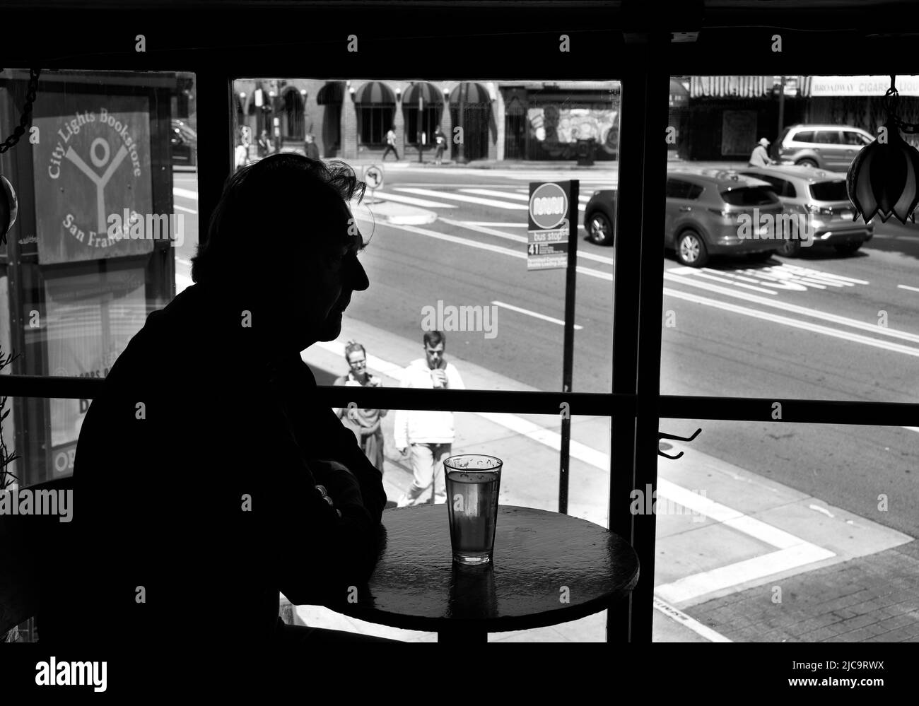 A man enjoys a pint of beer  at Vesuvio Cafe, a landmark bar in San Francisco, California, frequented by members of the 1950s Beat Generation. Stock Photo