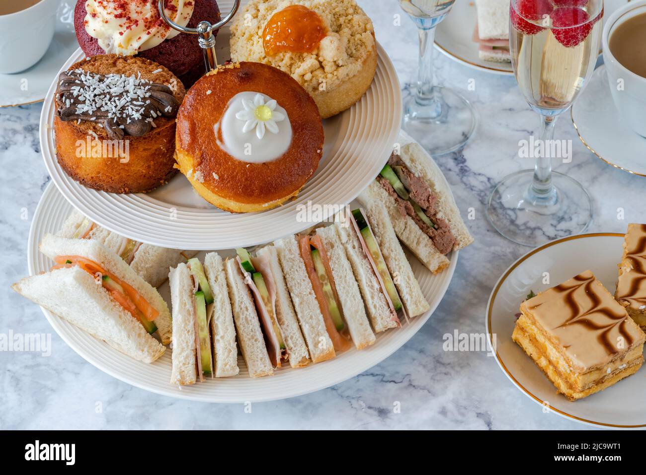 Selection of gourmet cakes and mini canapes with coffee and sparkling wine on a table Stock Photo