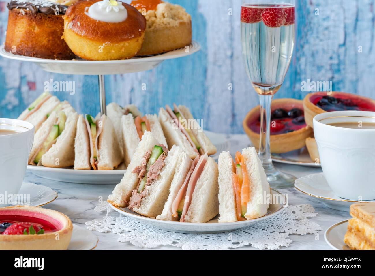 Selection of gourmet cakes and mini canapes with coffee and sparkling wine on a table Stock Photo