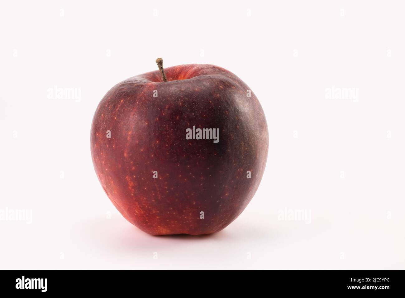 Red apple isolated on bright background. Close up view. Stock Photo