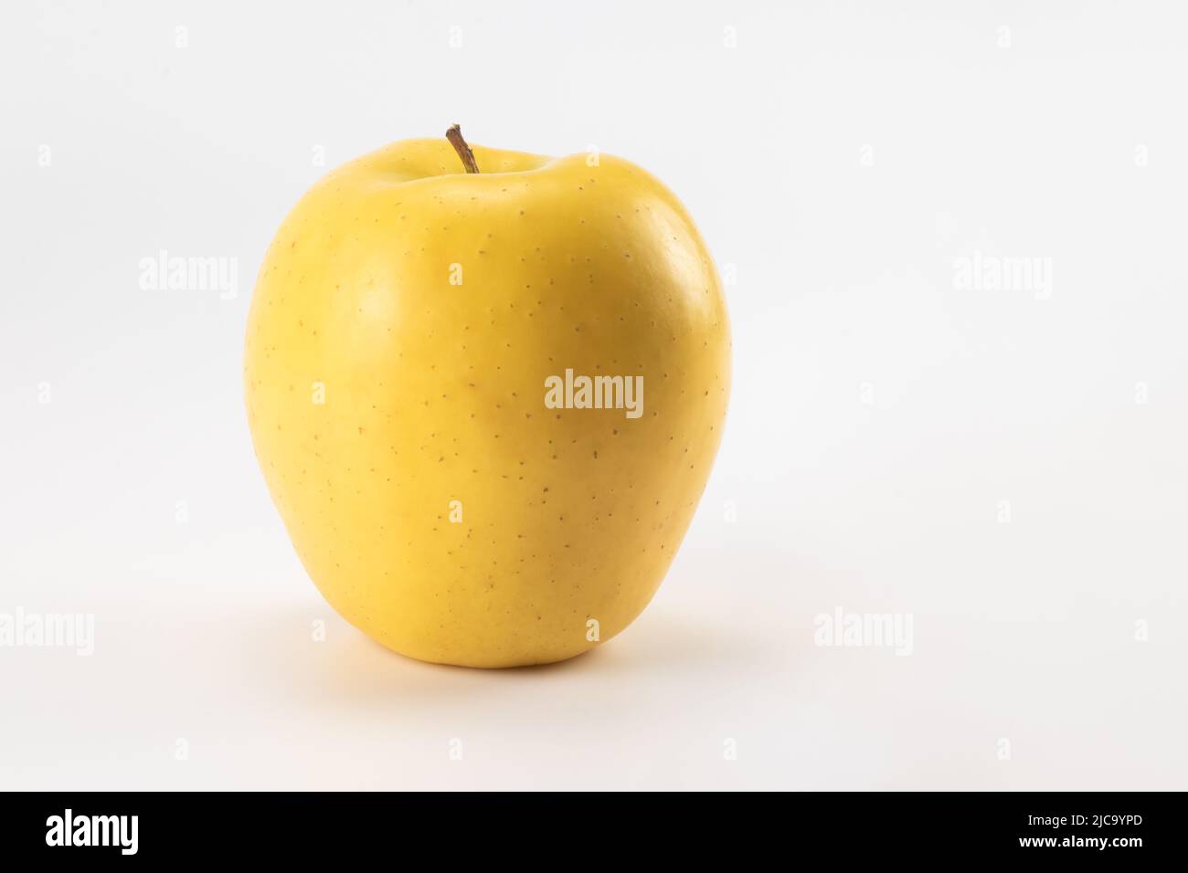 Yellow apple isolated on bright background. Close up view. Stock Photo