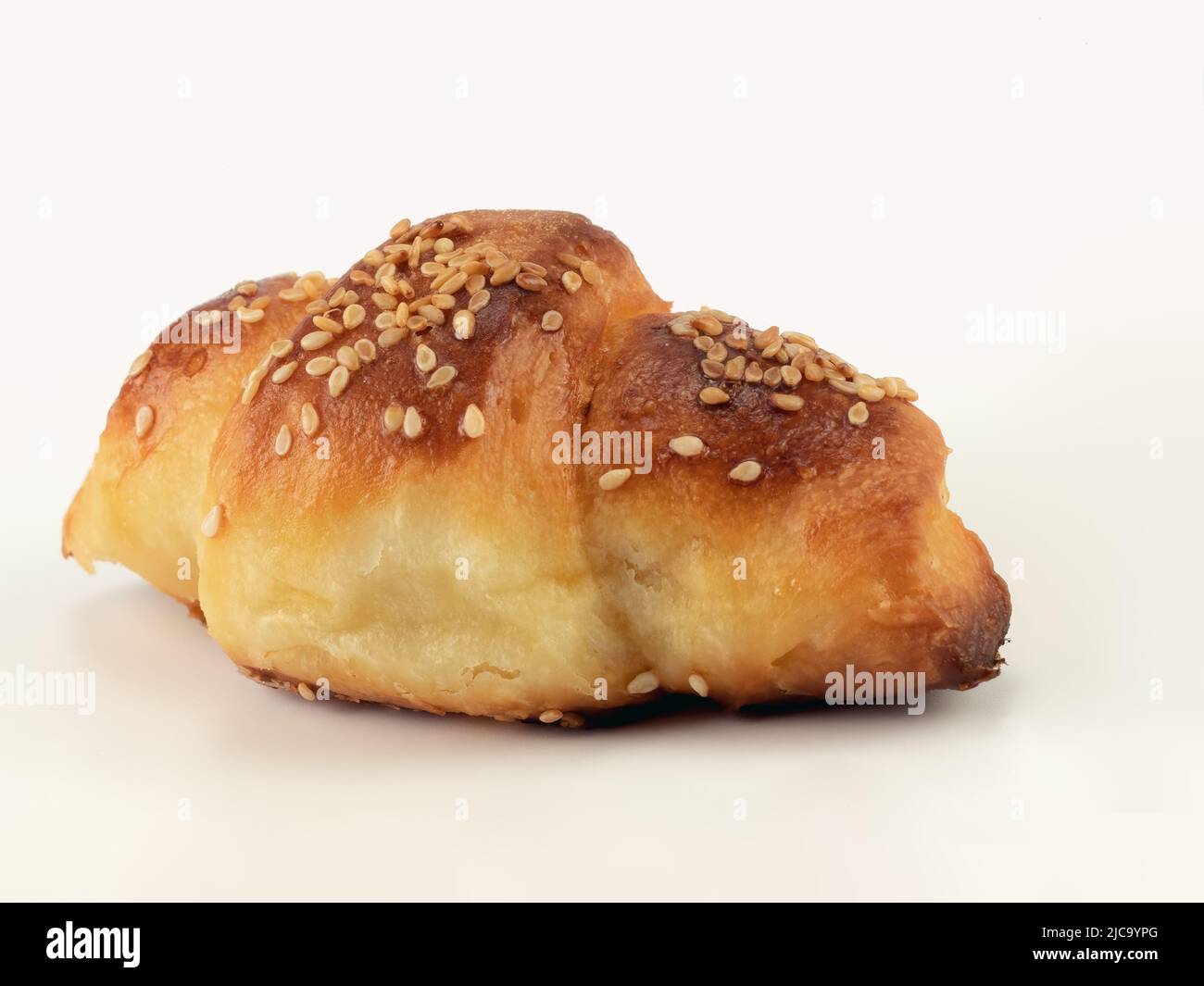 Homemade baked roll with sesame seeds. Close up view. Stock Photo