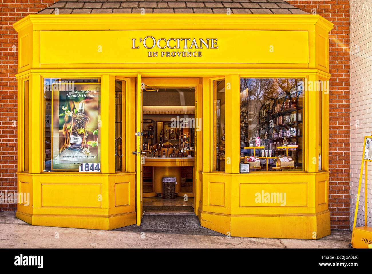 2022-04-06 Tulsa USA L Occitane en Provence perfume and body care store - Yellow wooden bay window storefront in Utica Square shopping Center - door s Stock Photo