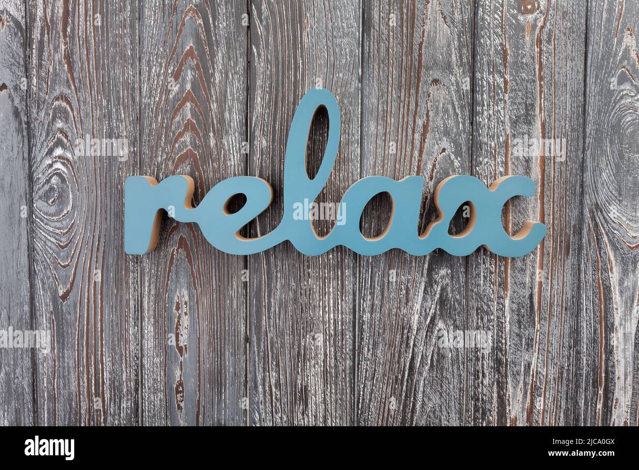carved wooden letters relax on wood background Stock Photo
