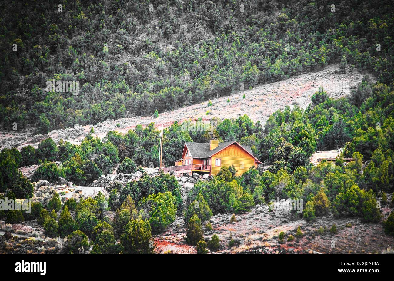 Beautiful luxury log cabin with wide deck on hill in Utah between Bryce and Zion - Pine tree covered hills Stock Photo