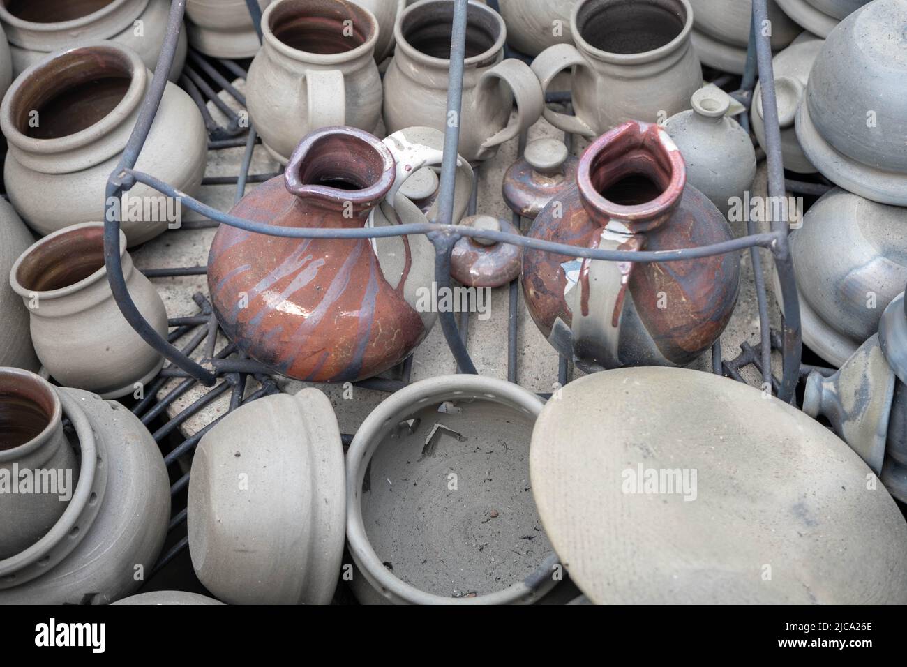 opening of a ceramic kiln, Unique handmade pots and dishes of clay