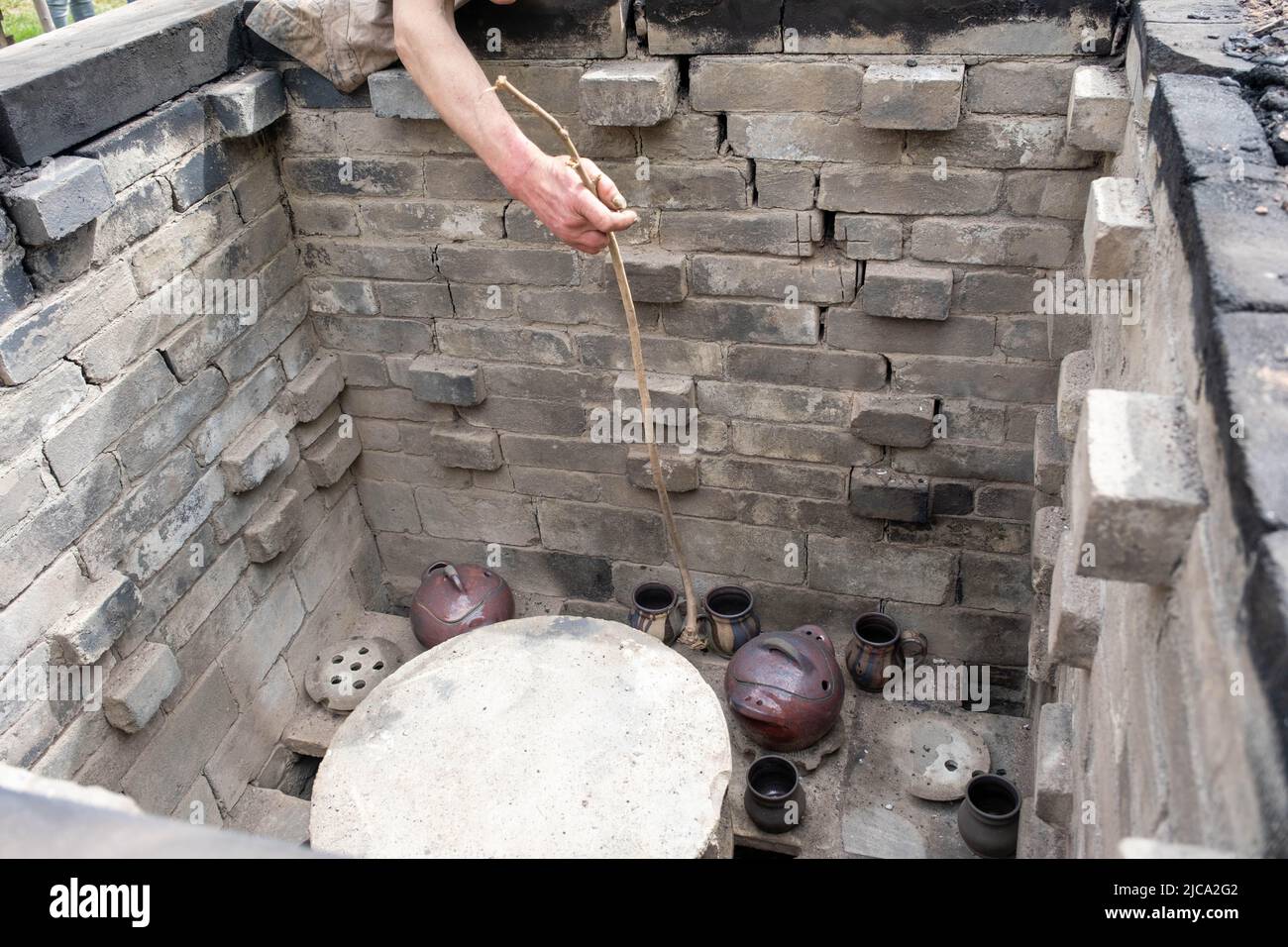 opening of a ceramic kiln, Unique handmade pots and dishes of clay