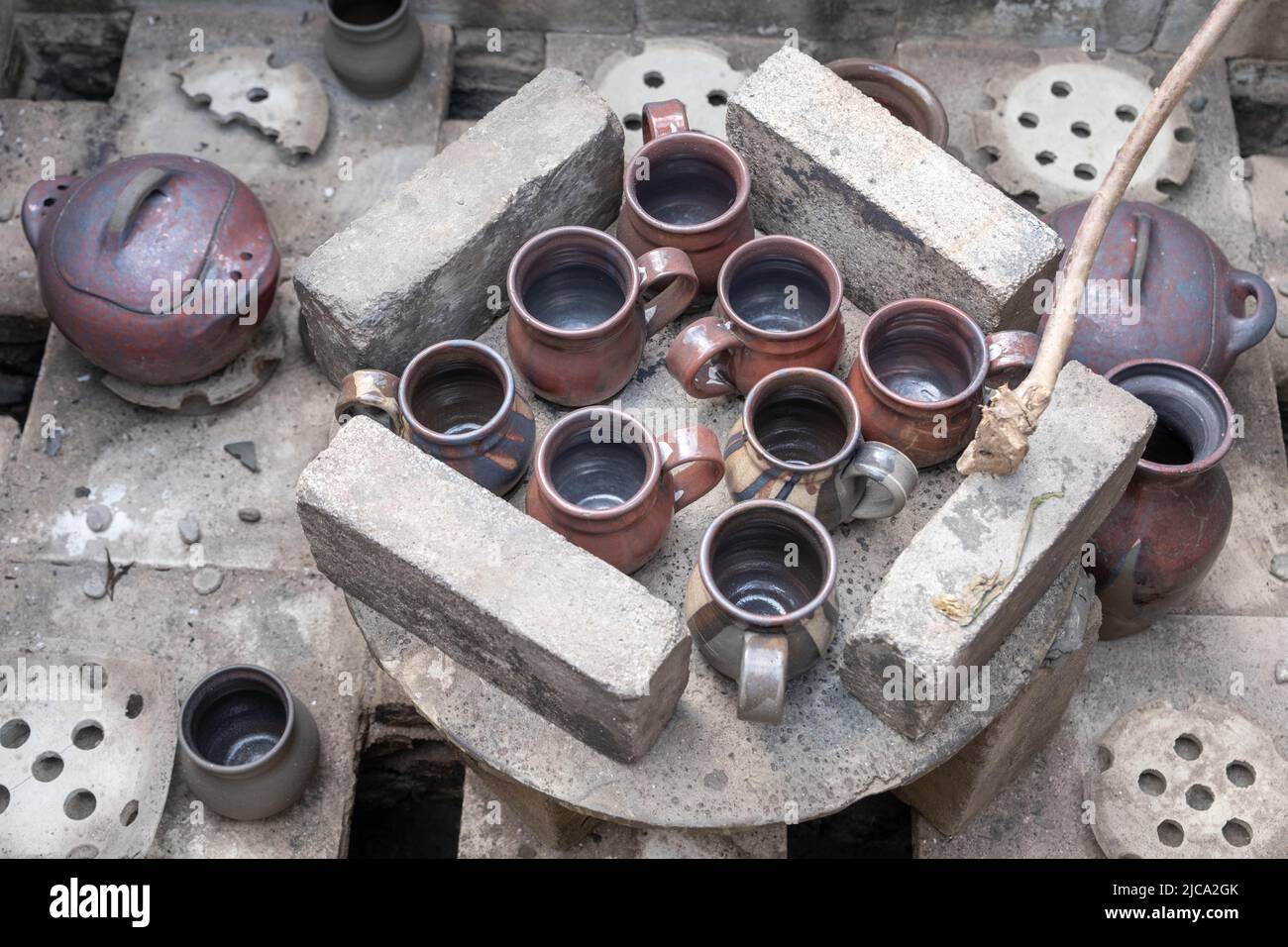 opening of a ceramic kiln, Unique handmade pots and dishes of clay