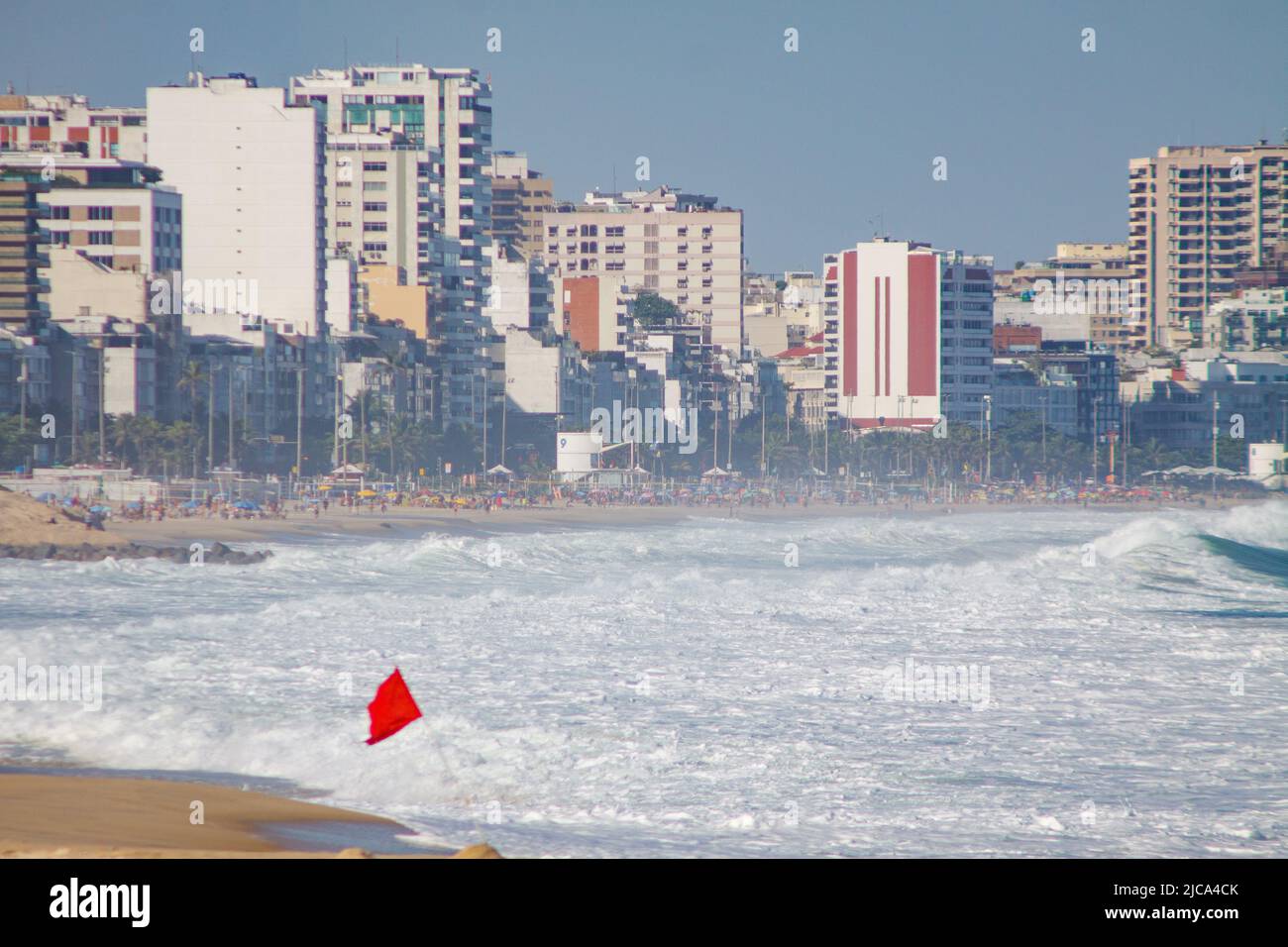 red flag signaling danger when entering the water at leblon beach in Rio de Janeiro Brazil. Stock Photo