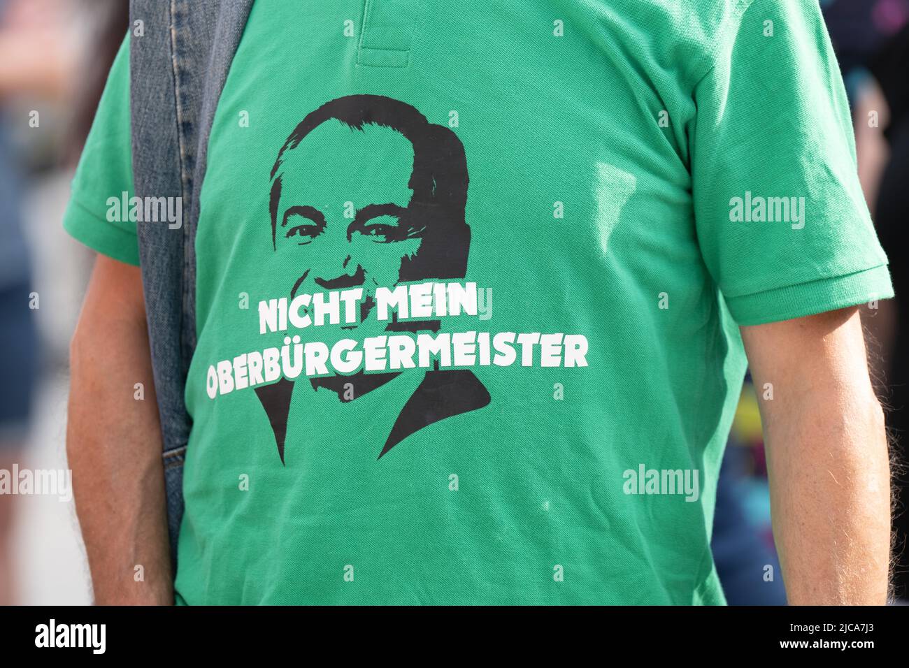 11 June 2022, Saxony, Görlitz: A participant in an AfD election campaign  event stands on Marienplatz wearing a T-shirt with a picture of Octavian  Ursu (CDU), mayor of Görlitz, and the inscription "