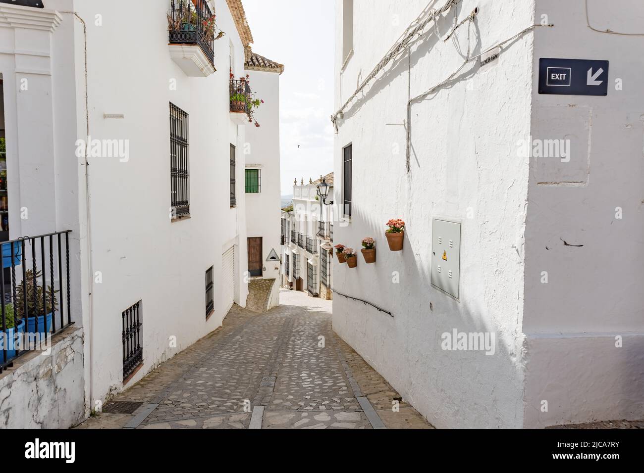 Typical narrow street in Zahara de la Sierra, in Sierra de Grazalema ...