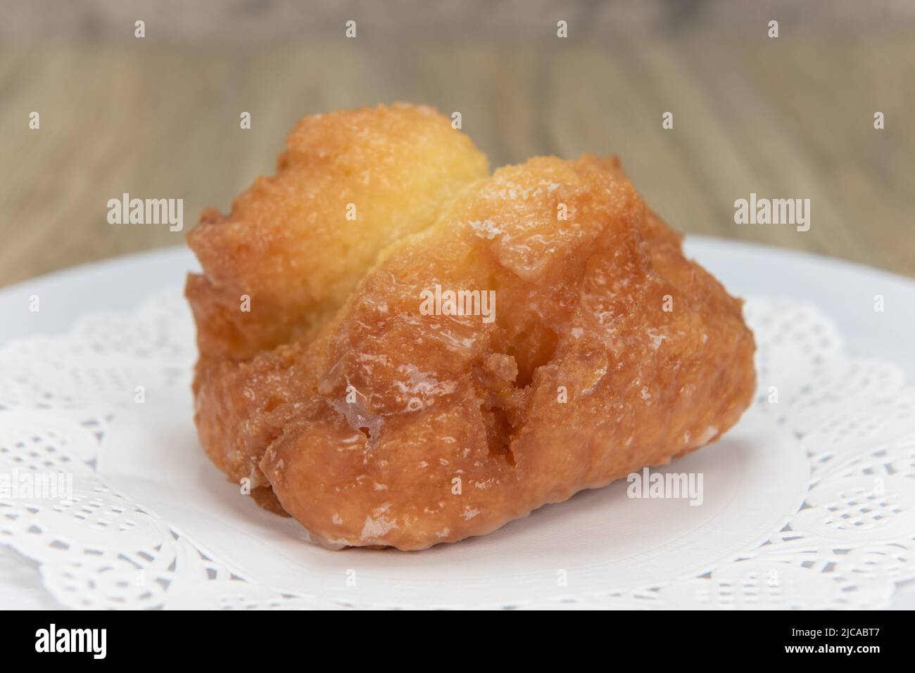 Tempting fresh from the oven buttermilk bar donut from the bakery served on a plate. Stock Photo