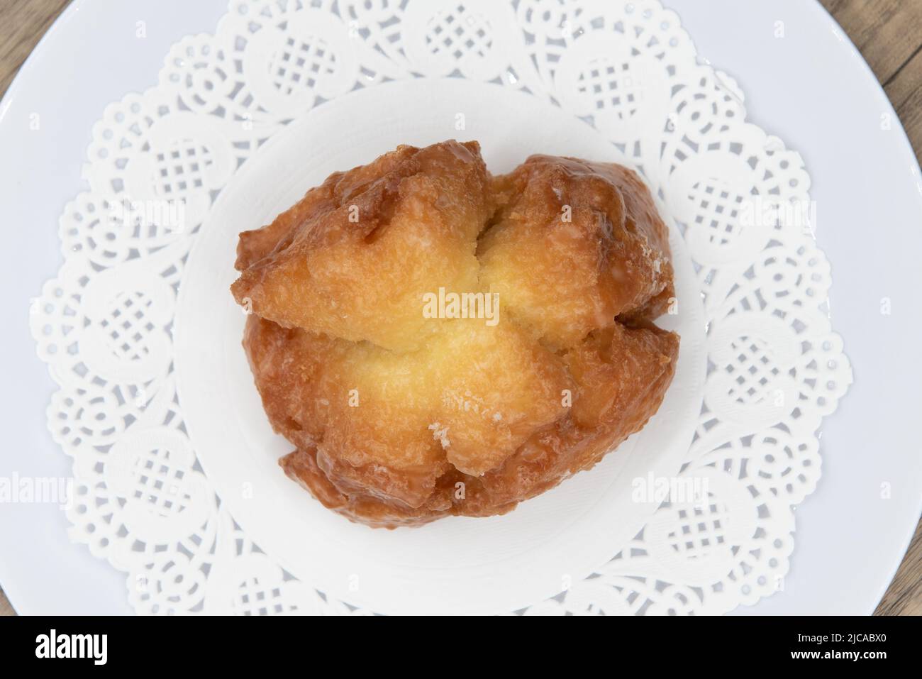 Overhead view of tempting fresh from the oven buttermilk bar donut from the bakery served on a plate. Stock Photo
