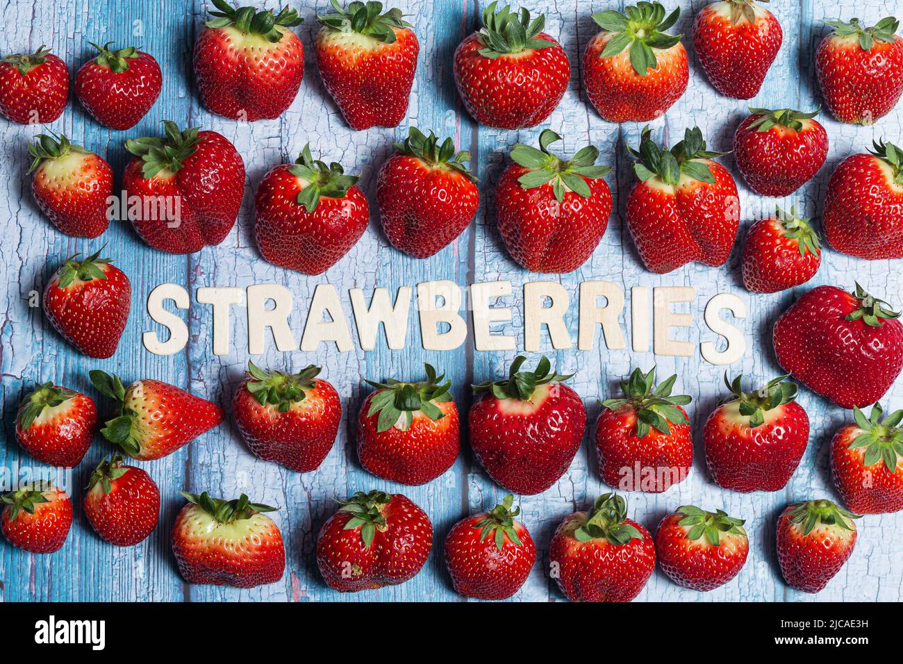 Many red strawberries fruit with strawberries word written Stock Photo