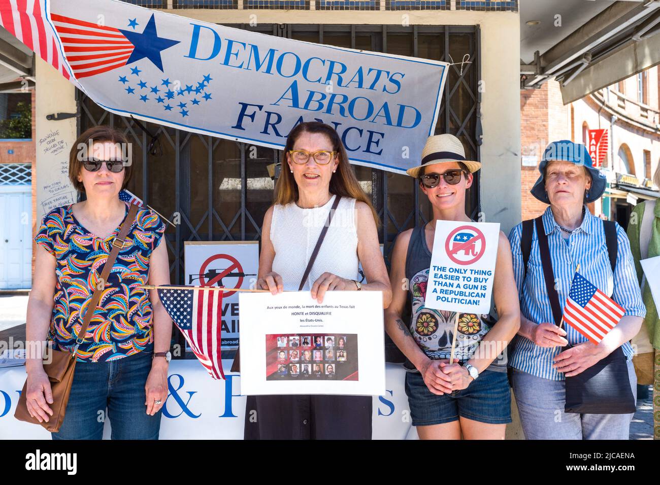 Group of American women, in front of a banner, Democrats Abroad France. One of the women holds a poster with pictures of the different victims, In the eyes of the world, the death of the children in Texas is HONORING and DISQUALIFIES the United States. Alexandria Ocaso-Cortez. Democratic Party rally abroad to honor the victims of the Robb Elementary School killing in Uvalde, Texas on May 24, 2022. France, Toulouse le 11 Juin 2022. Photo by Patricia Huchot-Boissier/ABACAPRESS.COM Stock Photo