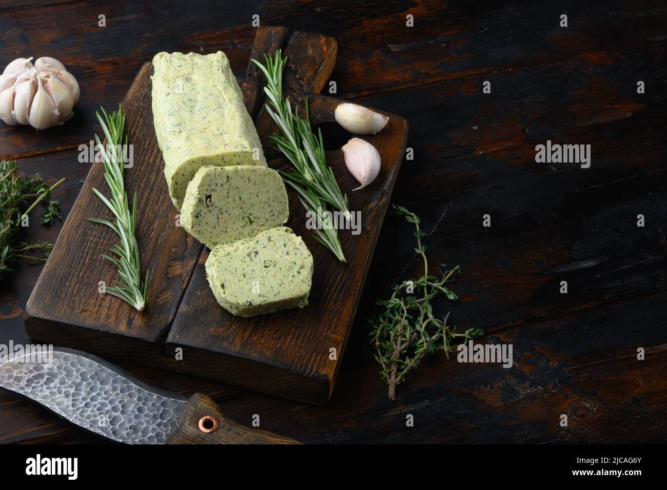 Homemade Organic Herb Butter with Rosemary Thyme and garlic set, on old