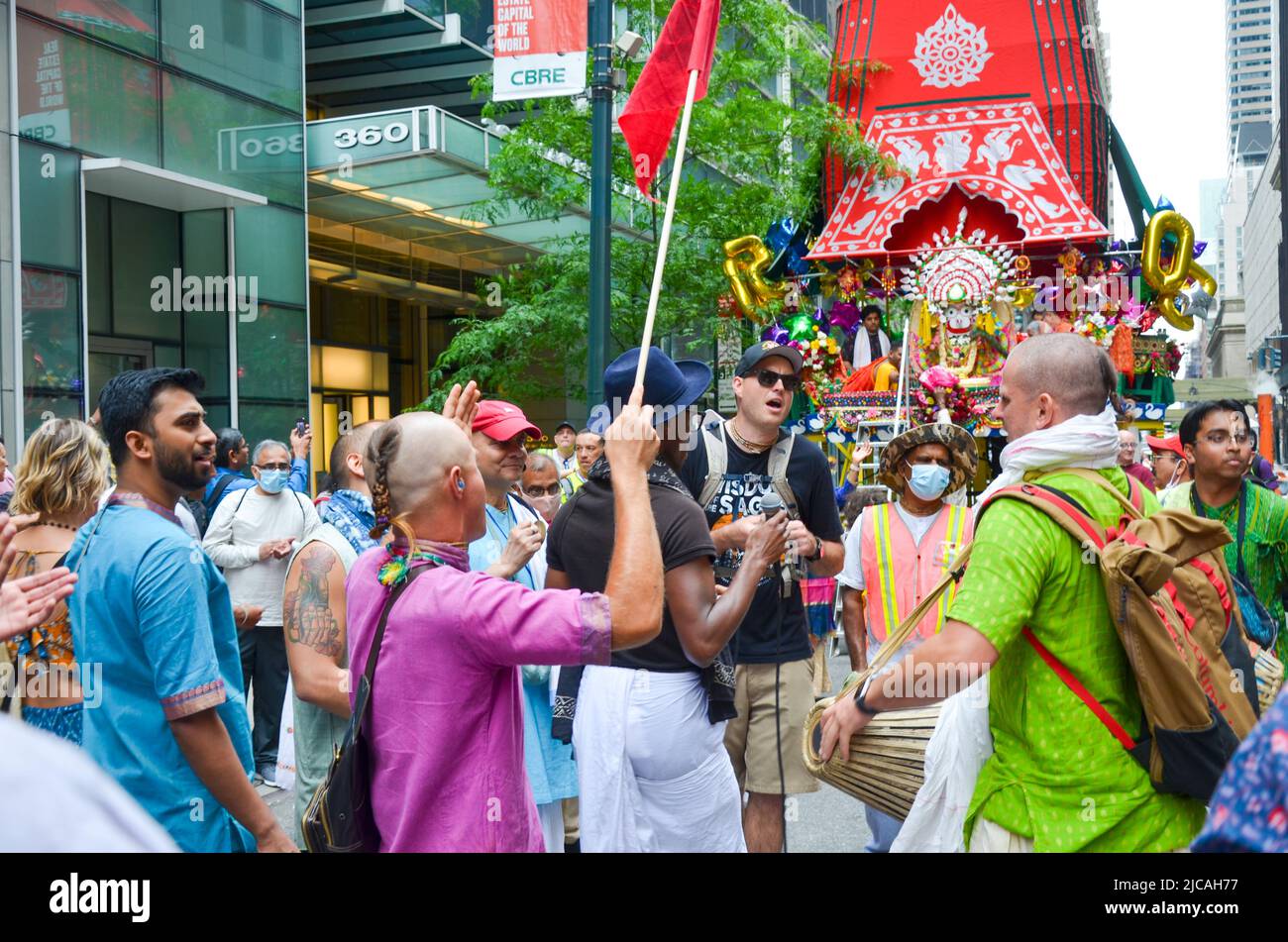 Hare Krishna followers are seen dancing on Fifth Avenue, New York City during the Hare Krishna Parade on June 11, 2022. Stock Photo