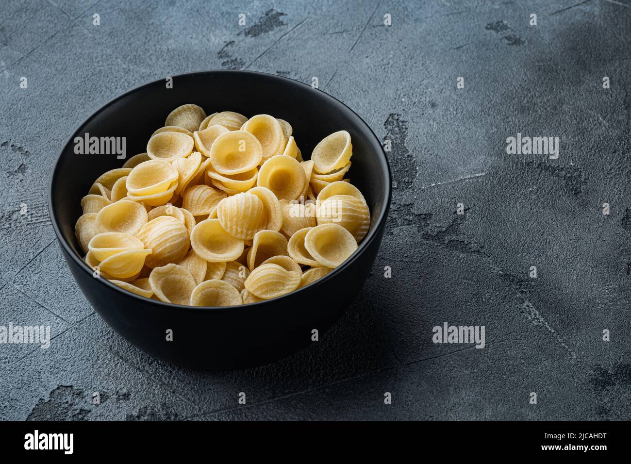 Durum wheat semolina pasta bowl, on gray background with copy space for text Stock Photo