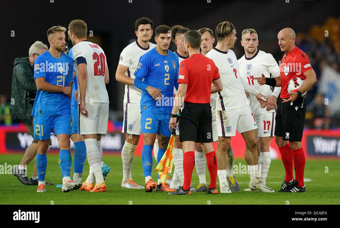England's Jack Grealish speaks with referee Szymon Marciniak after the final whistle during the UEFA Nations League match at the Molineux Stadium, Wolverhampton. Picture date: Saturday June 11, 2022. Stock Photo