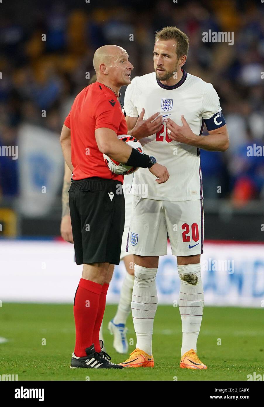 England's Harry Kane speaks with referee Szymon Marciniak after the final whistle during the UEFA Nations League match at the Molineux Stadium, Wolverhampton. Picture date: Saturday June 11, 2022. Stock Photo