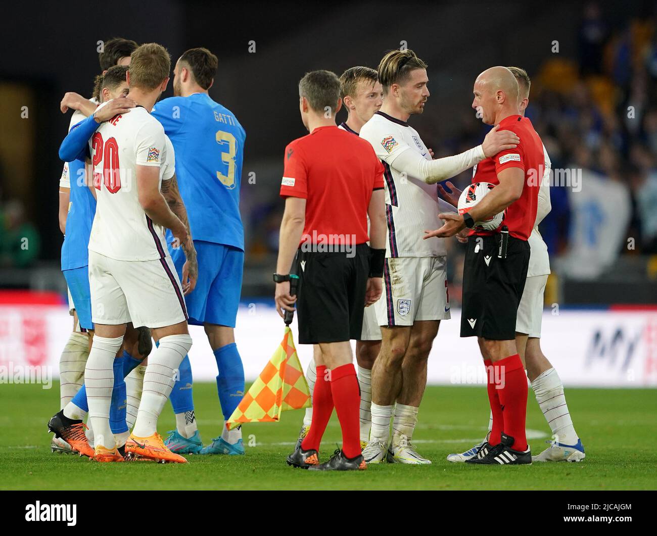 England's Jack Grealish speaks with referee Szymon Marciniak after the final whistle during the UEFA Nations League match at the Molineux Stadium, Wolverhampton. Picture date: Saturday June 11, 2022. Stock Photo