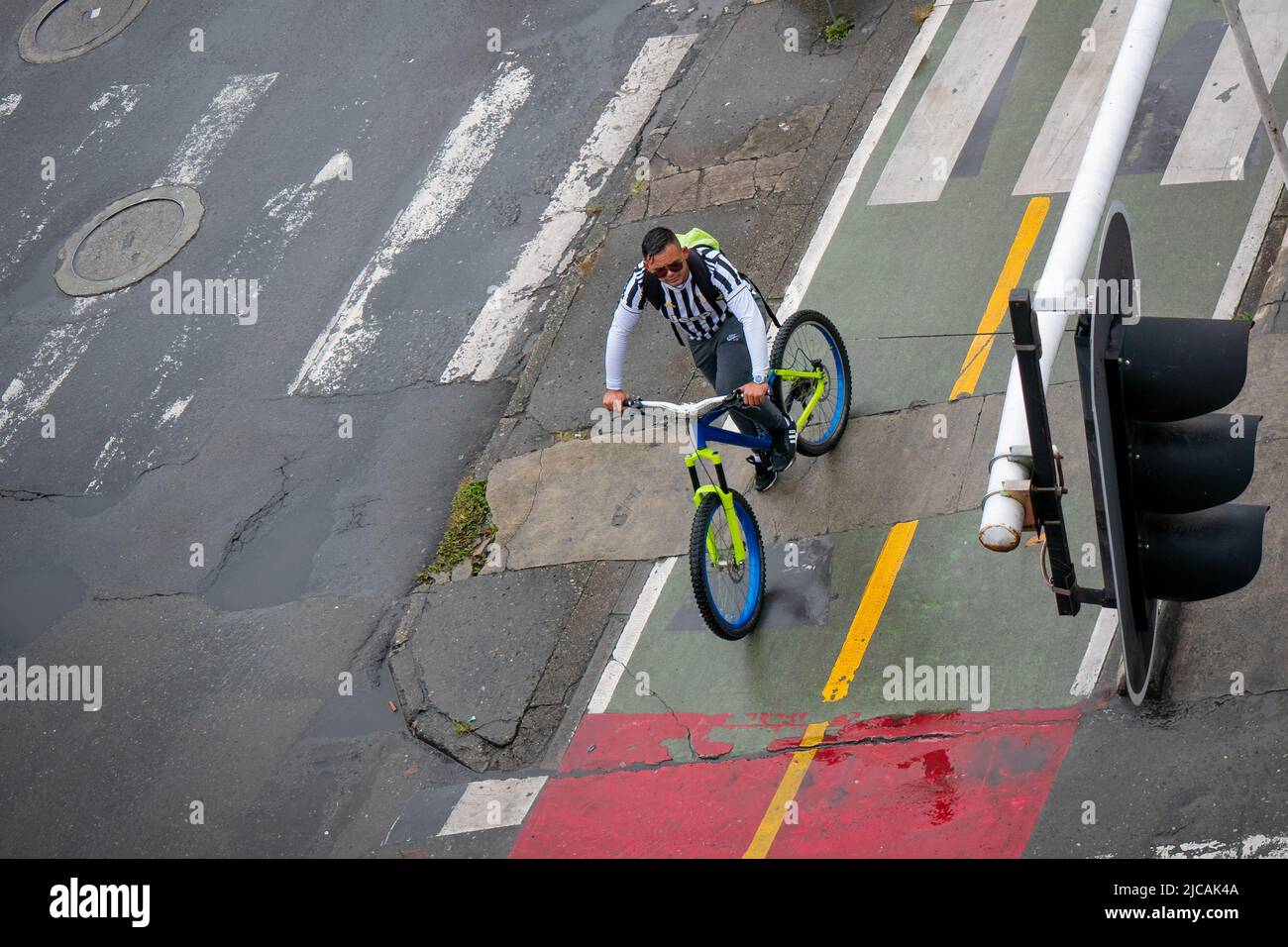 Medellin, Antioquia, Colombia - March 6 2022: Colombian Man Rides his Bicycle in the Morning on the Bike Path Stock Photo