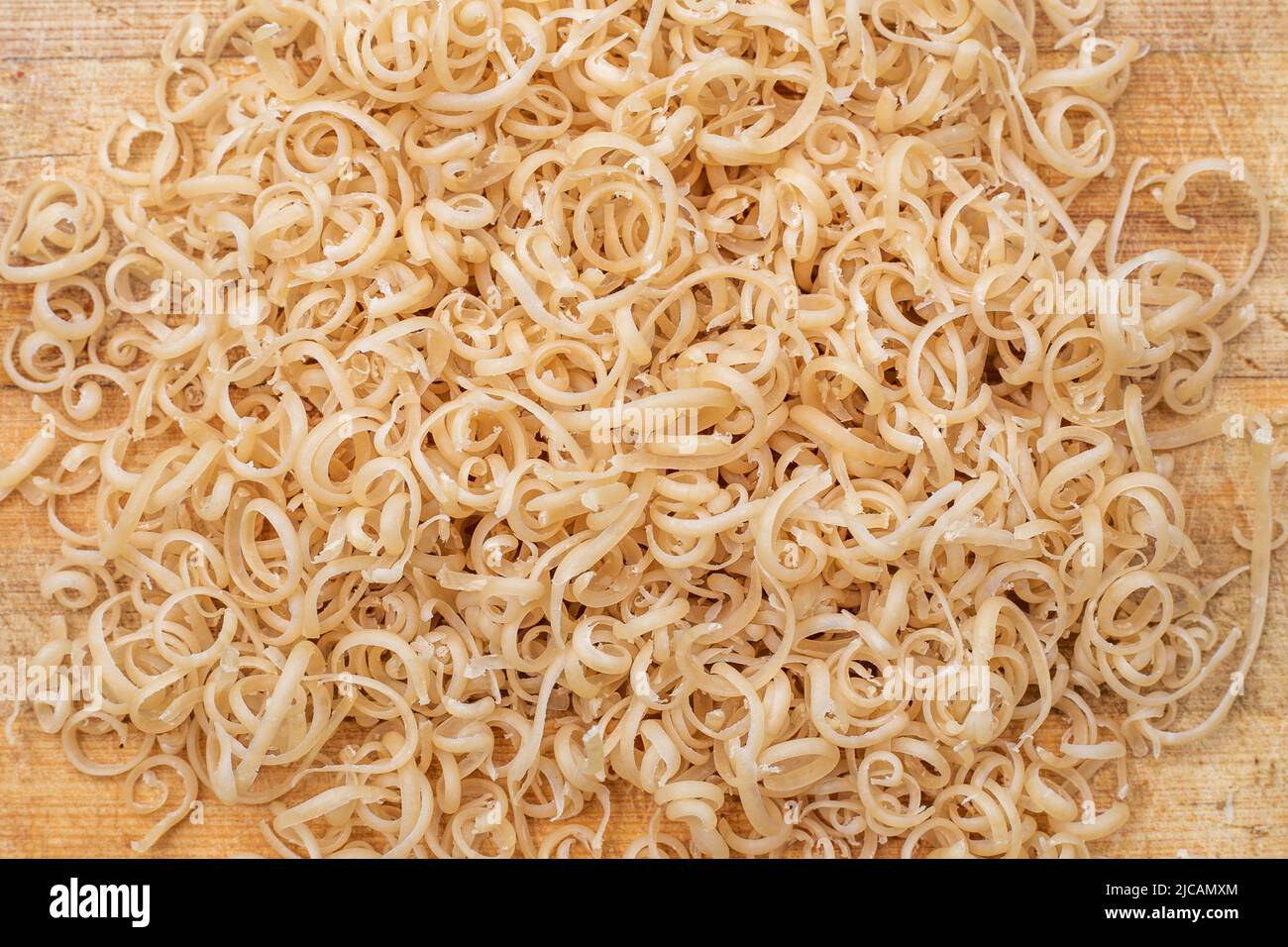 https://c8.alamy.com/comp/2JCAMXM/soap-shavings-on-a-wooden-board-small-spirals-of-grated-laundry-soap-2JCAMXM.jpg