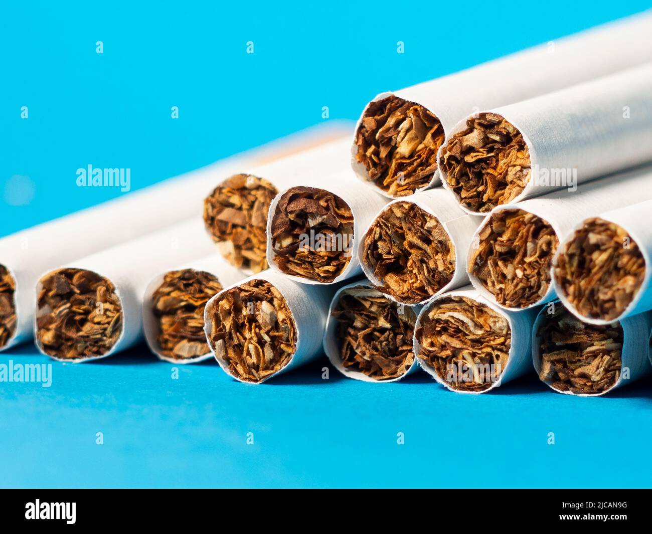 image of tobacco cigarette filters on blue background. Concept of