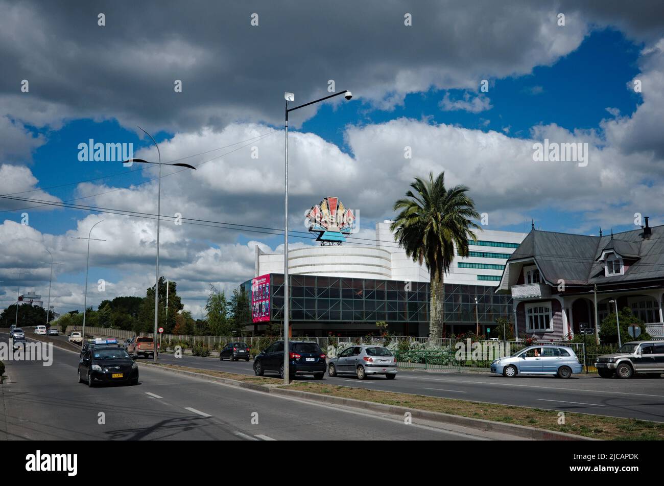 Osorno, Chile - February, 2020: Highway, casino and palm tree. View of Casino Marina del Sol Osorno and Avenida Republica street. Stock Photo