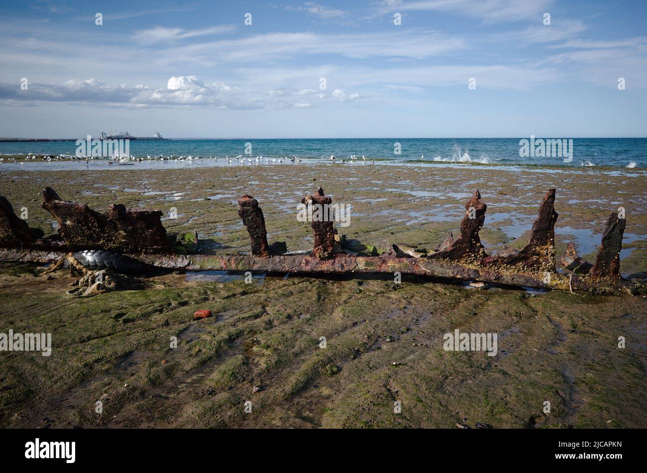 Piece of rusty metal remains from ship on coast of Atlantic Ocean near Puerto Madryn, Chubut, Patagonia, Argentina. Piece of corrosion metal Stock Photo