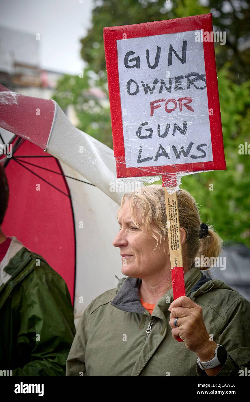 A participant carries a sign in a June 11, 2022, March for our Lives in Eugene, Oregon, USA. The marchers, angered by a spate of recent mass shootings Stock Photo