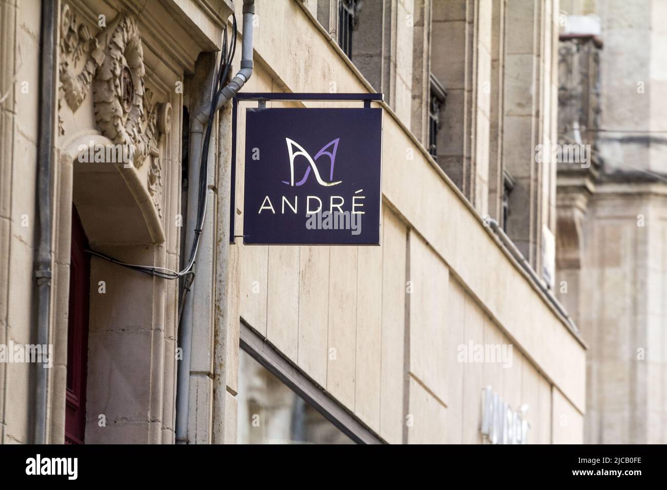 Picture of a shop with a sign with the logo of Andre. André is a French