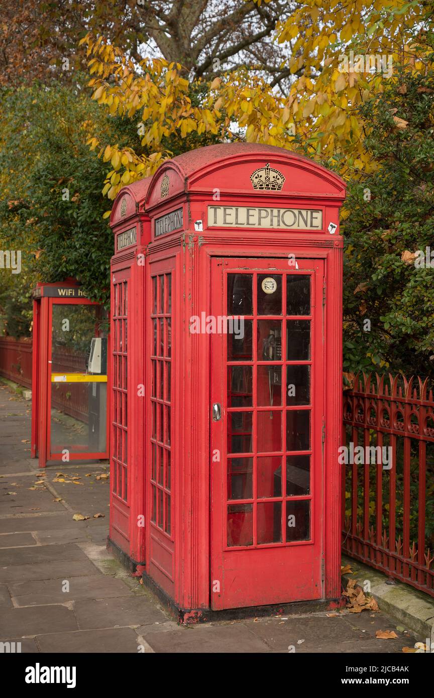 Old fashioned red London telephone booths.  Exhibition Road, South Kensington, London. Stock Photo