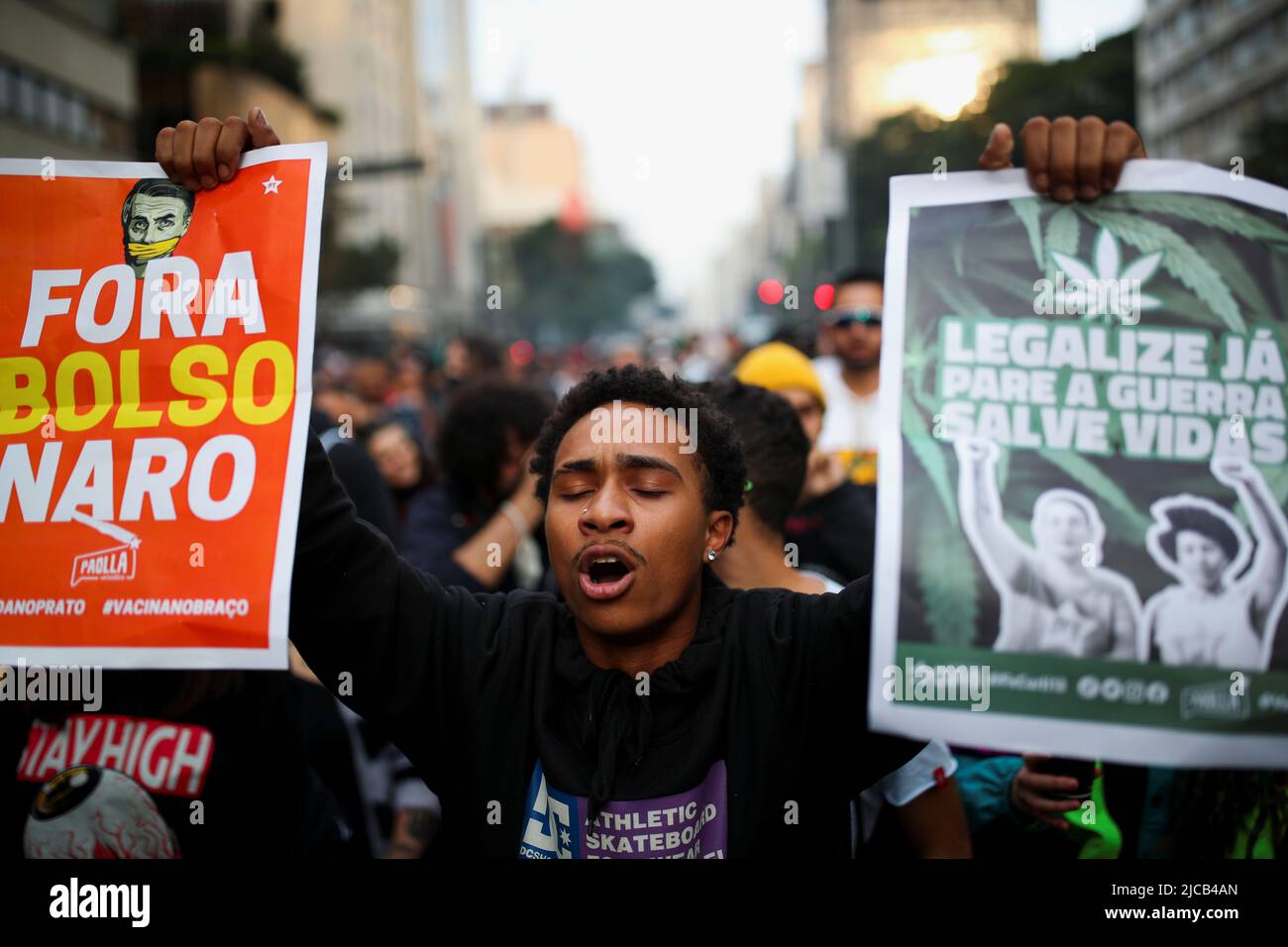 A man shouts as he takes part in the march for marijuana, in favor of the decriminalization of cannabis, in Sao Paulo, Brazil June 11, 2022. The banners read 'Out Bolsonaro' and 'Legalize Now, Stop the war, save lives.' REUTERS/Amanda Perobelli Stock Photo