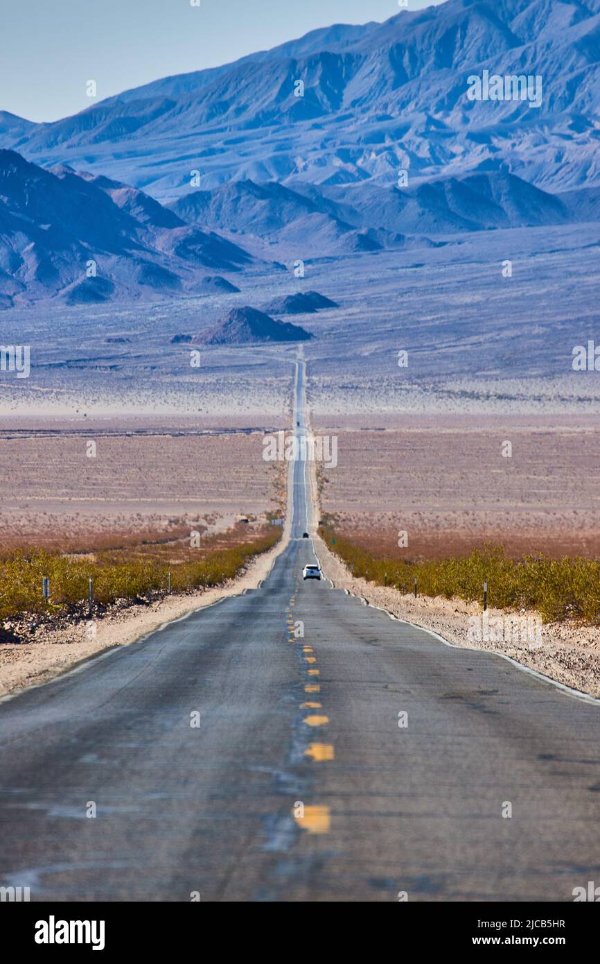 Long road going up into desert mountains Stock Photo
