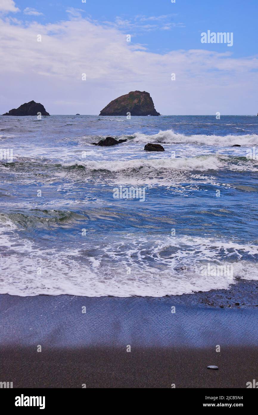 Waves on sandy shore black hi-res stock photography and images - Alamy