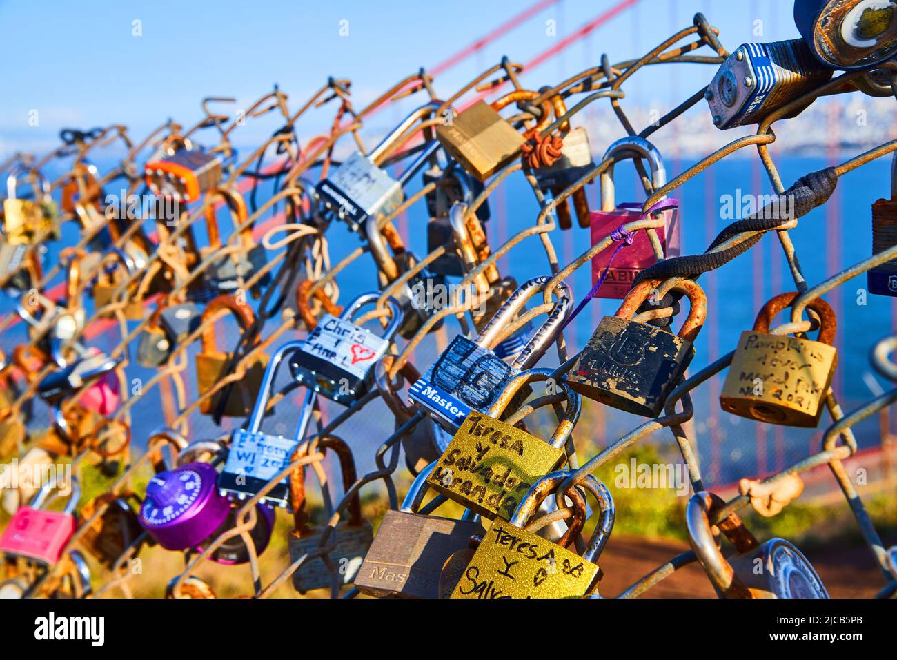Locks covering up chain linked fence in San Francisco Stock Photo