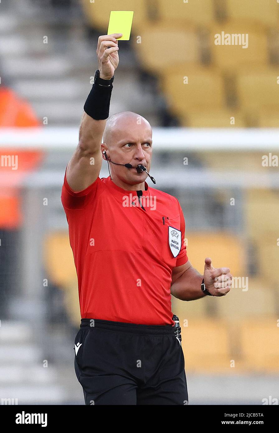 Wolverhampton, England, 11th June 2022.  Referee Szymon Marciniak shows a yellow card during the UEFA Nations League match at Molineux, Wolverhampton. Picture credit should read: Darren Staples / Sportimage Stock Photo