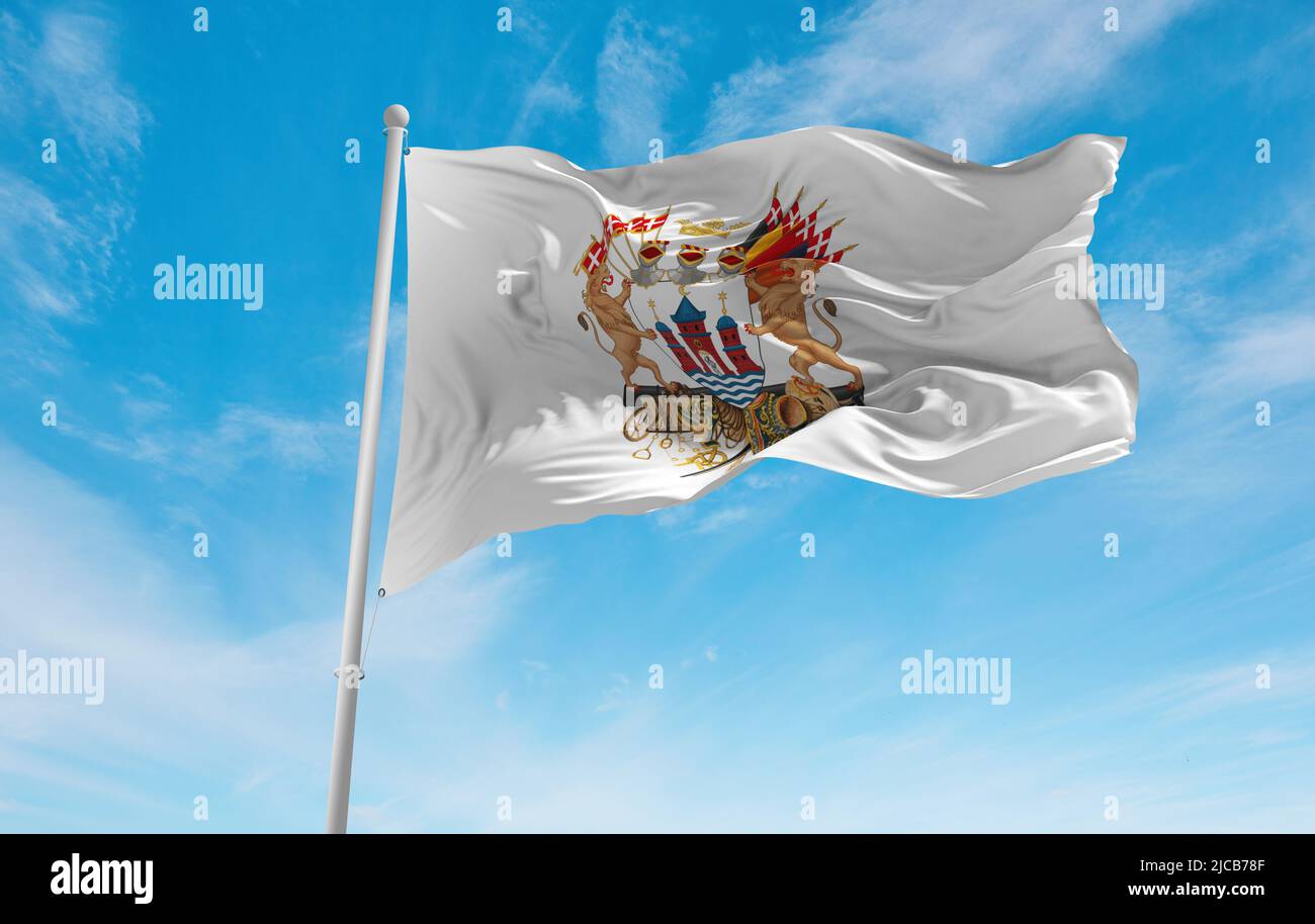 official flag of Greater Copenhagen , Denmark at cloudy sky background on sunset, panoramic view. Danish travel and patriot concept. copy space for wi Stock Photo