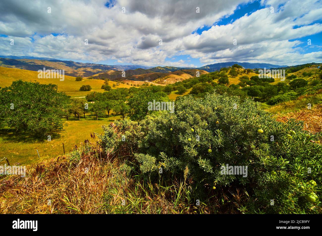 Stunning spring landscape looking over mountains with clouds Stock Photo